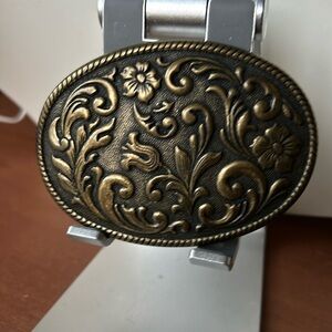 Brass belt buckle with flower motif